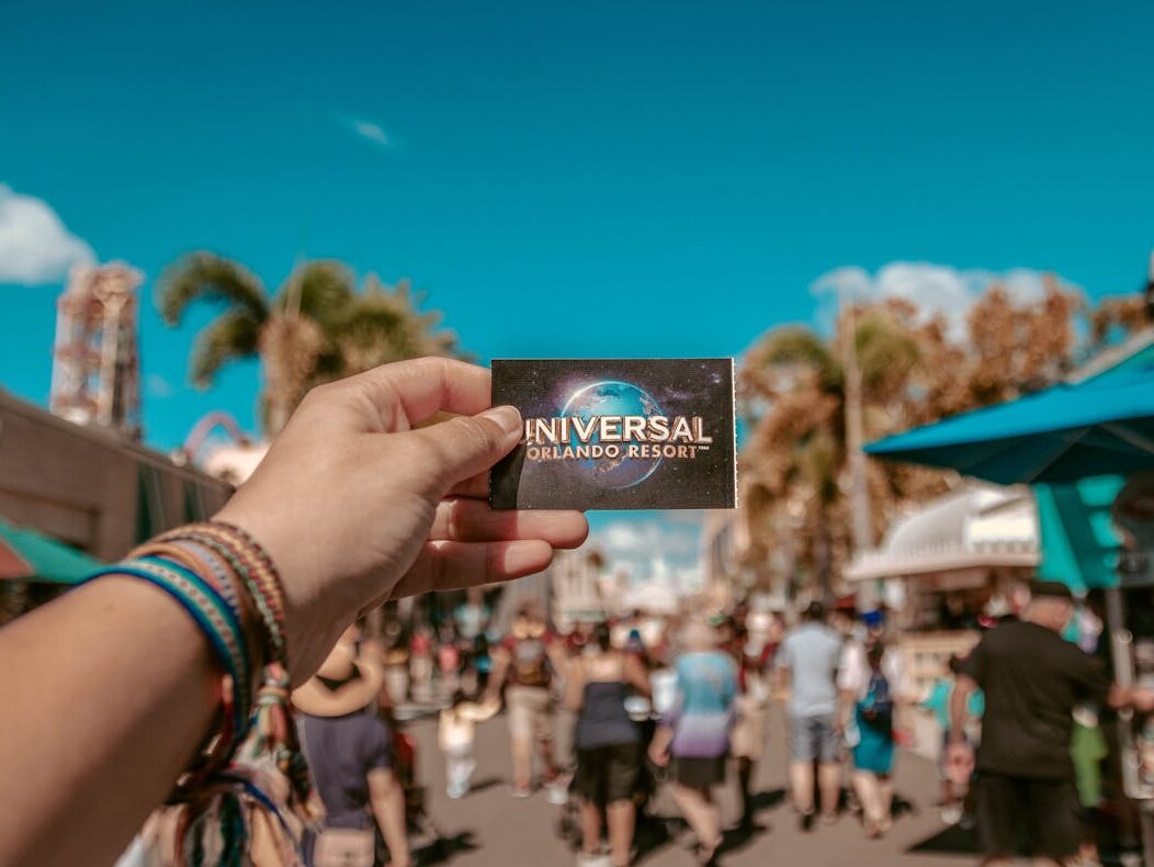 person holding universal studios ticket
