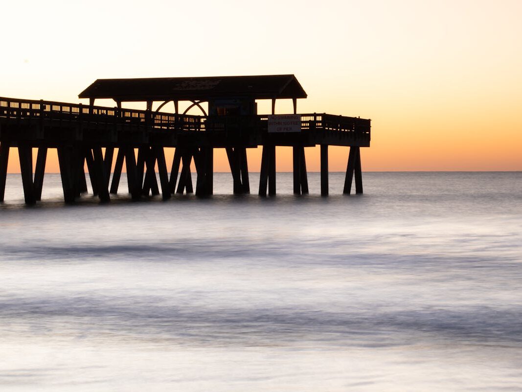 silhouette of a pier against the sunset