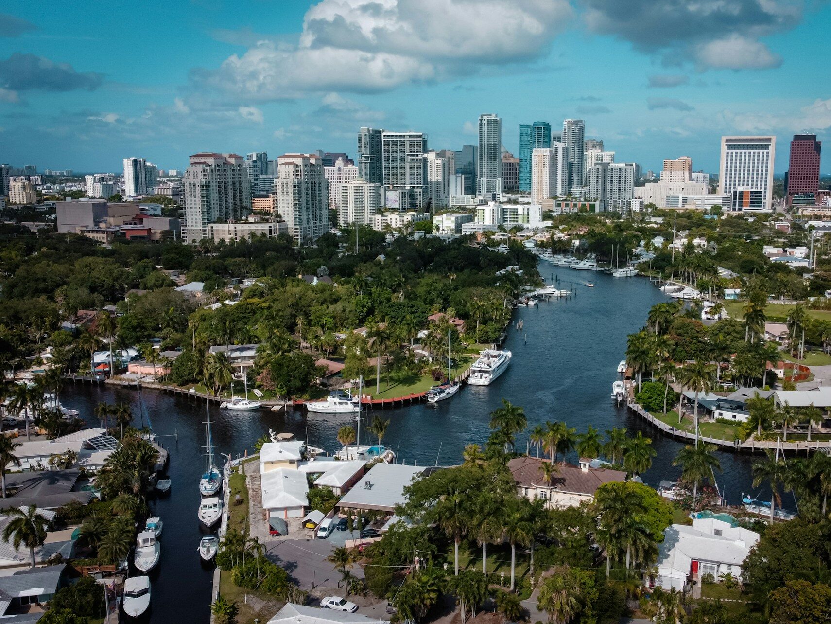 city skyline over a canal with boats