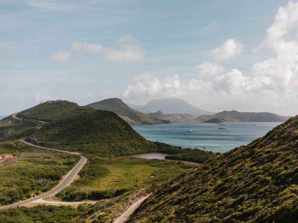green mountains near the ocean