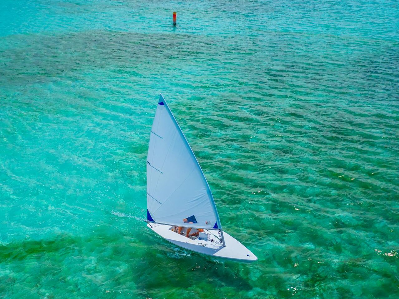 sailboat sailing on blue sea coast