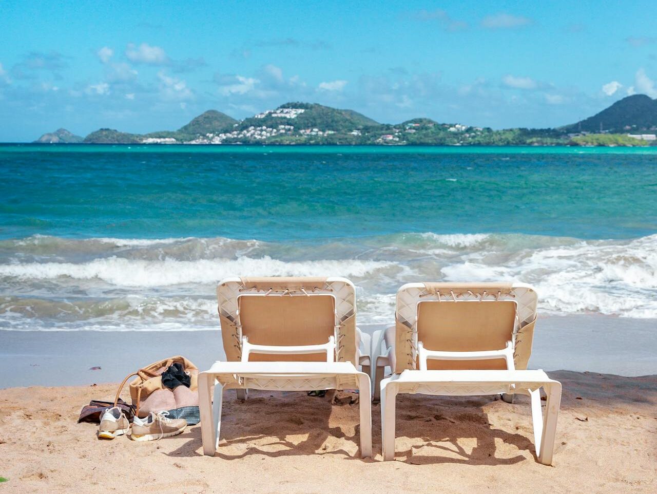 sunloungers on sandy beach